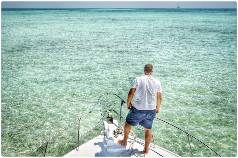 rear-view-man-standing-boat-sea