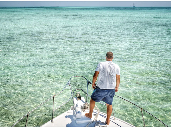 rear-view-man-standing-boat-sea